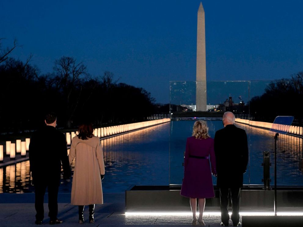 PHOTO: Vice President-elect Kamala Harris and President-elect Joe Biden watch as a Covid-19 Memorial is lit at the Lincoln Memorial in Washington, DC, Jan. 19, 2021 to honor the lives of those lost to Covid-19.