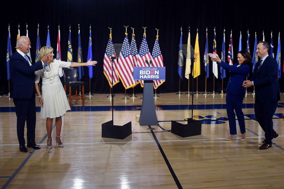 PHOTO: Democratic presidential nominee and former Vice President Joe Biden and his wife Jill Biden wave to his running mate, Sen. Kamala Harris and her husband Douglas Emhoff after their first press conference together in Wilmington, Del., Aug. 12, 2020.