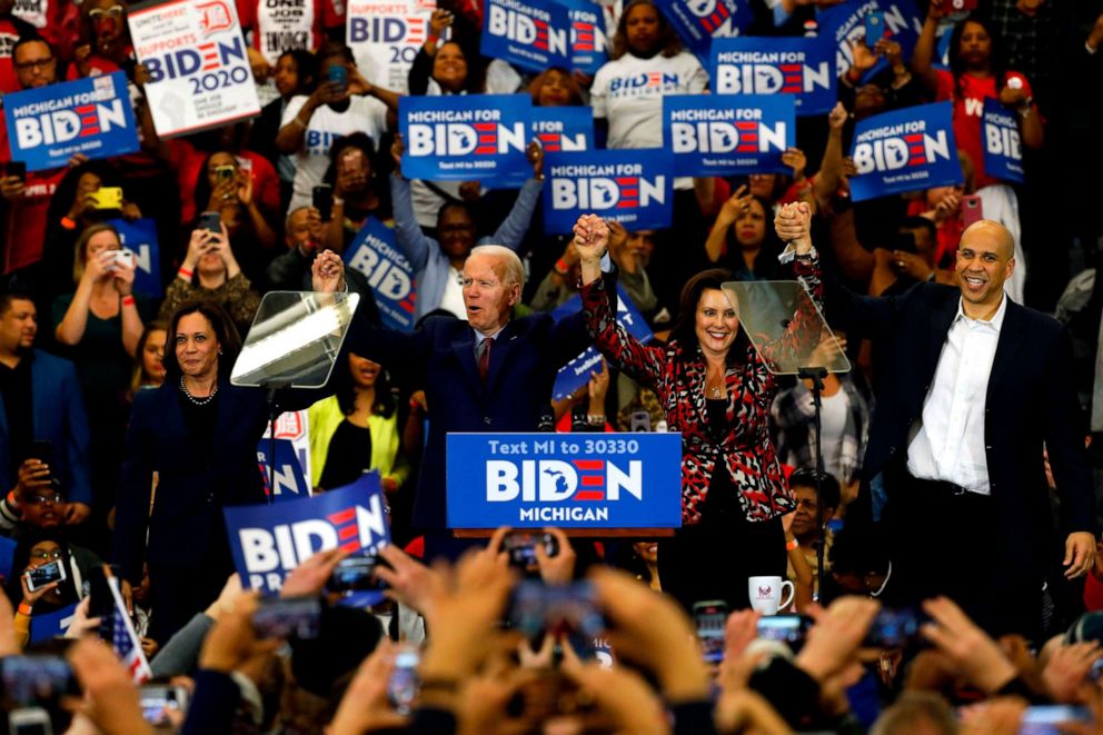 PHOTO: Sen. Kamala Harris, Democratic presidential candidate former Vice President Joe Biden, Michigan Governor Gretchen Whitmer and Sen. Cory Booker hold hands onstage during a campaign rally at Renaissance High School in Detroit, March 9, 2020.