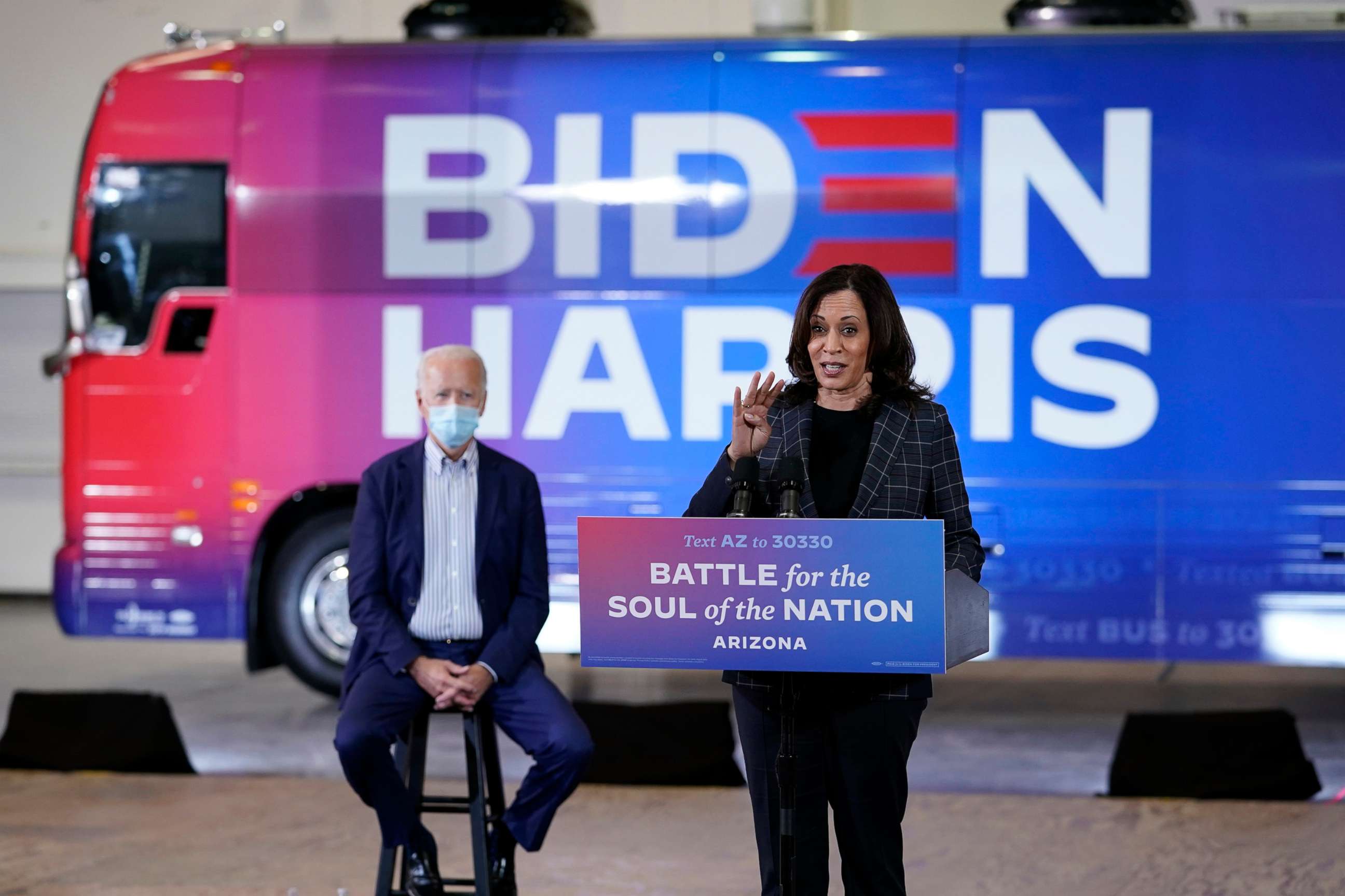 PHOTO: Democratic presidential candidate former Vice President Joe Biden listens as Democratic vice presidential candidate Sen. Kamala Harris, speaks at the Carpenters Local Union 1912 in Phoenix, Oct. 8, 2020, to kick off a small business bus tour.