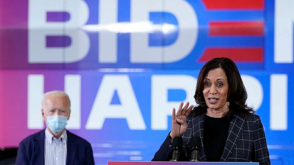 PHOTO: Democratic presidential candidate former Vice President Joe Biden listens as Democratic vice presidential candidate Sen. Kamala Harris, speaks at the Carpenters Local Union 1912 in Phoenix, Oct. 8, 2020, to kick off a small business bus tour.