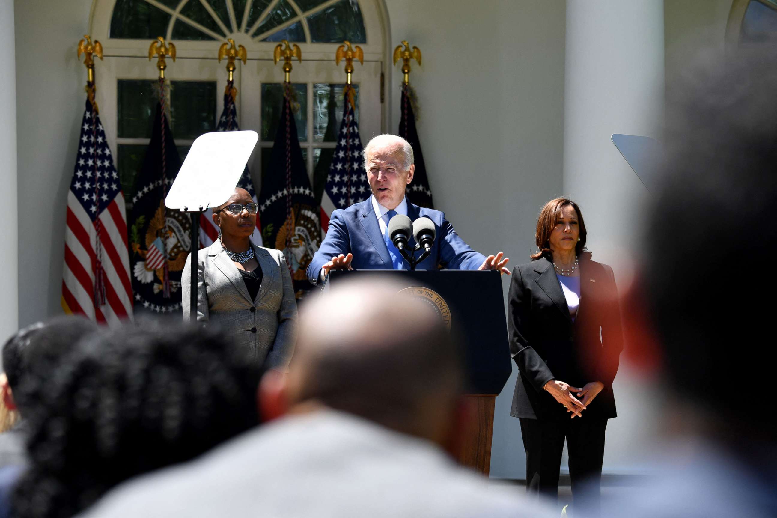 PHOTO: Alicia Jones, a beneficiary of the internet program and Vice President  Harris listen as President Joe Biden delivers remarks on lowering the cost of high speed internet, in the Rose Garden of the White House in Washington, D.C, on May 9, 2022.