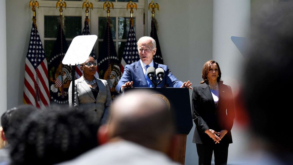 PHOTO: Alicia Jones, a beneficiary of the Internet program and Vice President Harris listens as President Joe Biden makes remarks about lowering the cost of high-speed Internet, at the Rose Garden of the White House in Washington, DC, on May 9, 2022.