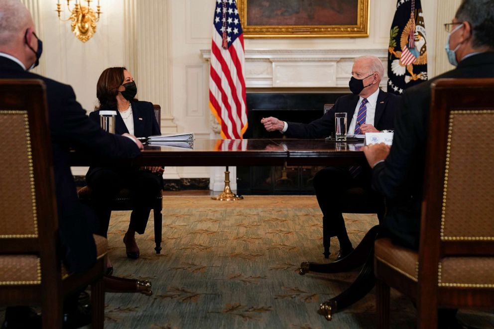 President Joe Biden speaks with Vice President Kamala Harris as they meet with Health and Human Services Secretary Xavier Becerra and Homeland Security Secretary Alejandro Mayorkas at the White House on March 24, 2021, in Washington.