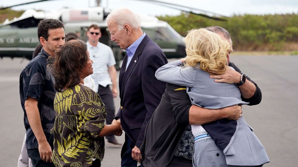 PHOTO: President Joe Biden greets Jaime Green, wife of Gov. Josh Green, as first lady Jill Biden hugs Hawaii Gov. Josh Green upon arrival on Air Force One to receive a briefing on the devastating Maui wildfires, Aug. 21, 2023, in Kahului, Hawaii.