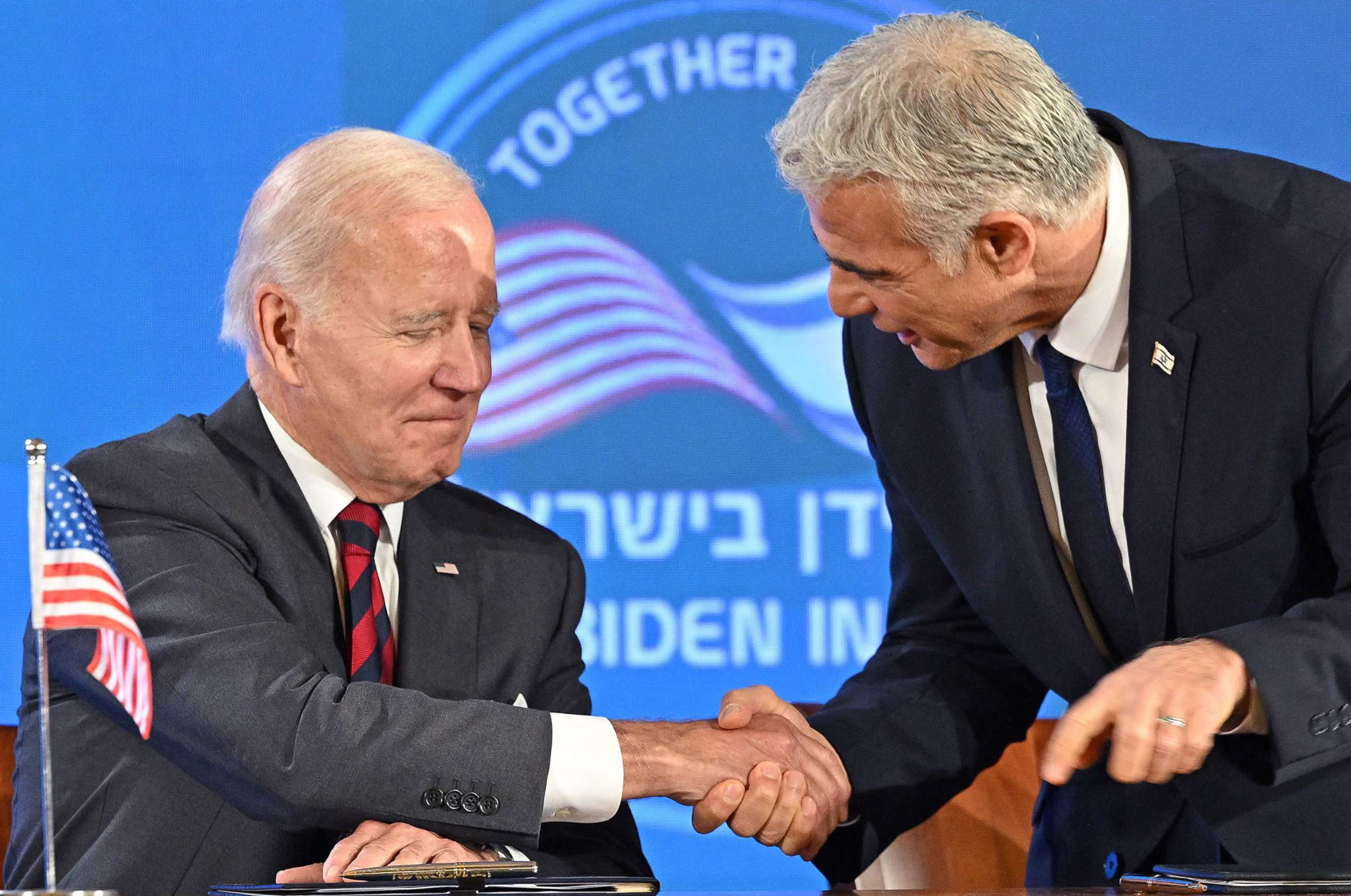 PHOTO: President Joe Biden and Israel's caretaker Prime Minister Yair Lapid shake hands before the start of a joint press conference in Jerusalem, on July 14, 2022. 