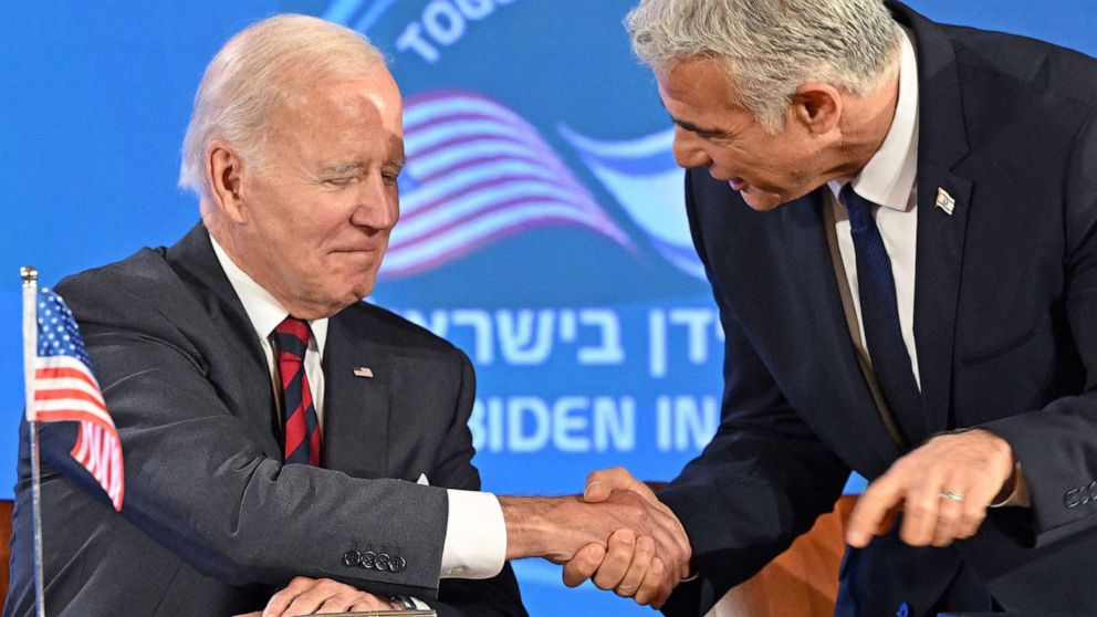 PHOTO: President Joe Biden and Israel's caretaker Prime Minister Yair Lapid shake hands before the start of a joint press conference in Jerusalem, on July 14, 2022. 