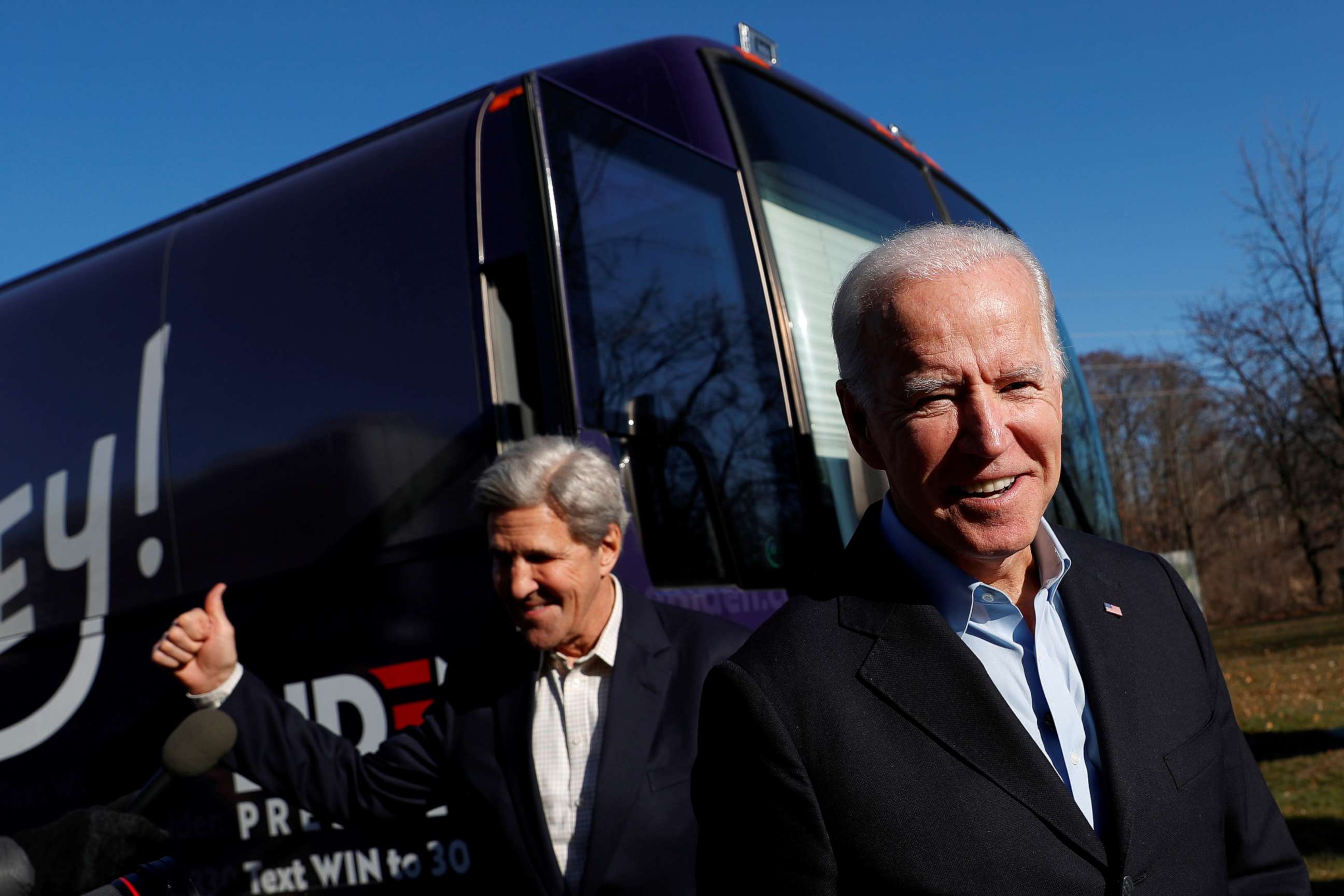 PHOTO: John Kerry and then-Democratic presidential candidate Joe Biden exit Biden's campaign bus in Cedar Rapids, Iowa, Dec. 6, 2019.