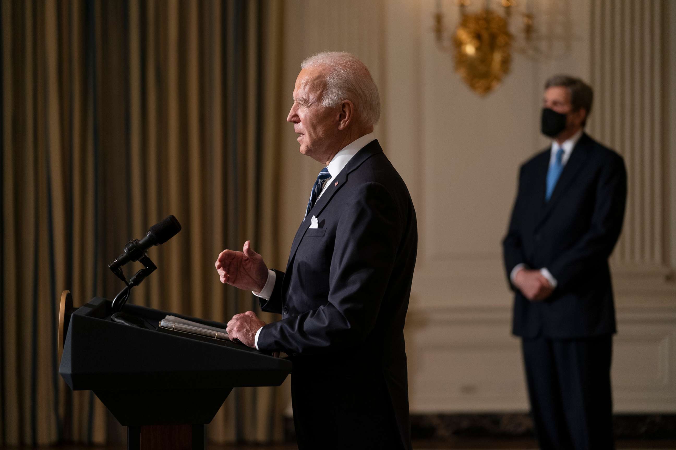 PHOTO: Special Presidential Envoy for Climate John Kerry, right, listens as President Joe Biden delivers remarks on climate change and green jobs, in the State Dining Room of the White House, Jan. 27, 2021.