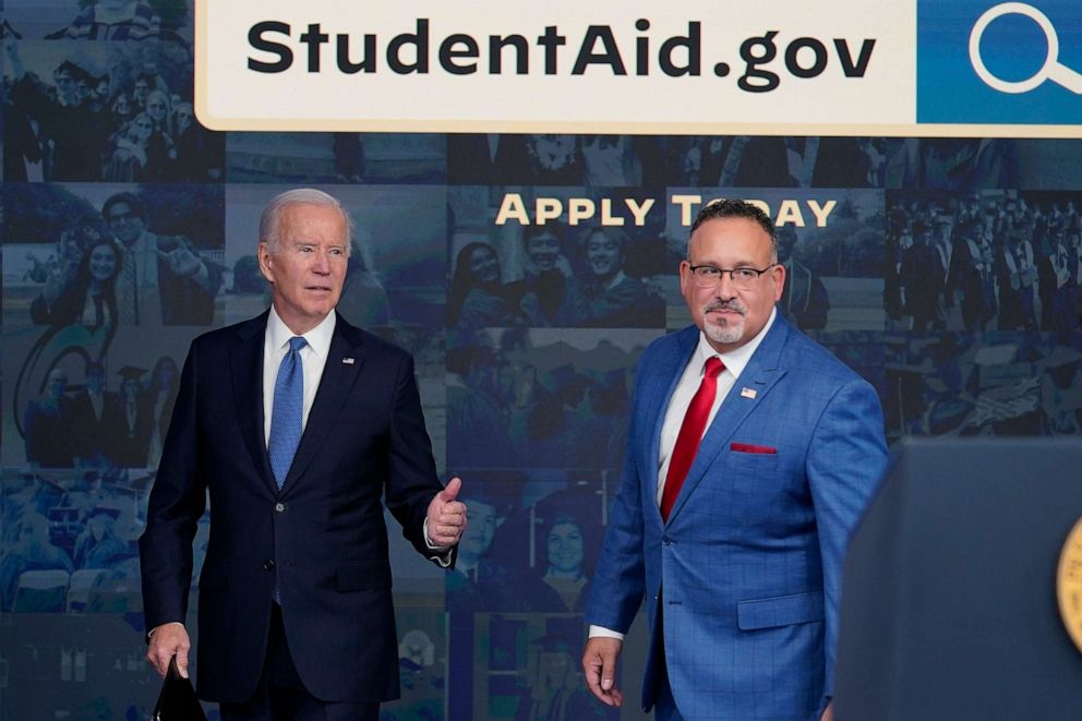 PHOTO: President Joe Biden answers questions with Education Secretary Miguel Cardona as they leave an event about the student debt relief portal beta test in the South Court Auditorium on the White House complex in Washington, Oct. 17, 2022.