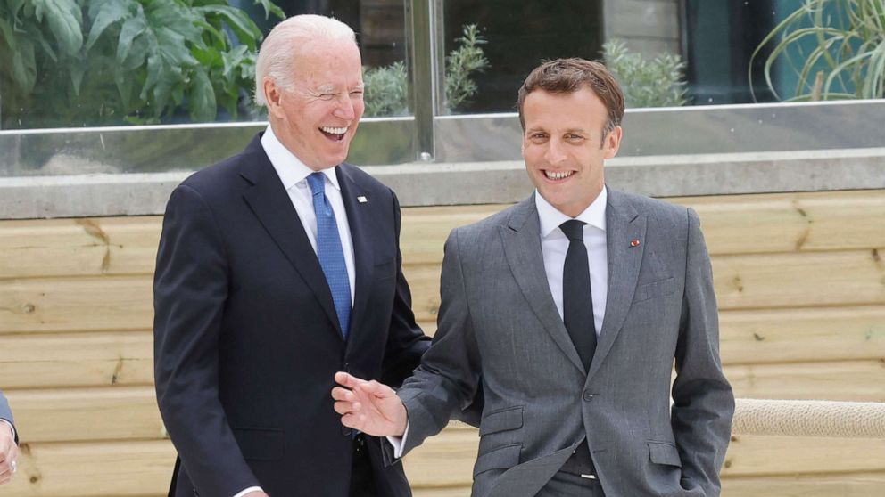 PHOTO: U.S. President Joe Biden and French President Emmanuel Macron share a light moment before the family photo at the start of the G-7 summit in Cornwall, England on June 11, 2021.