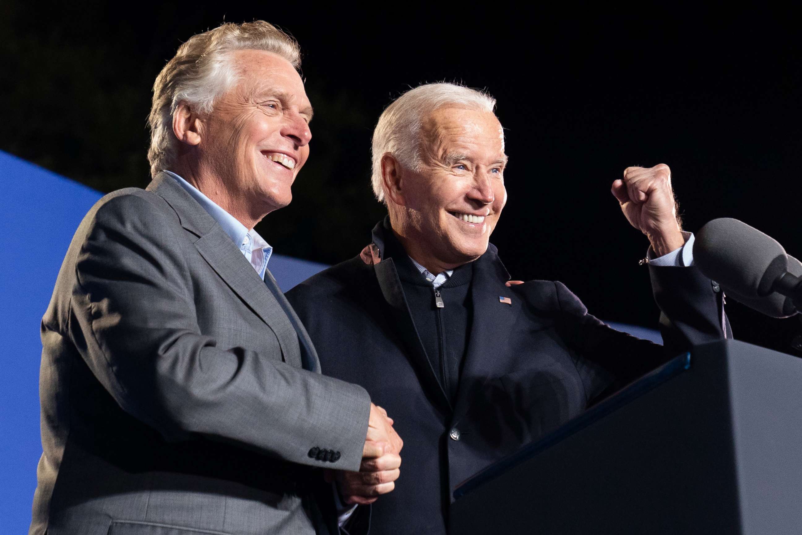 PHOTO: President Joe Biden, right, reacts after speaking at a rally for Democratic gubernatorial candidate, former Virginia Gov. Terry McAuliffe, Tuesday, Oct. 26, 2021, in Arlington, Va.