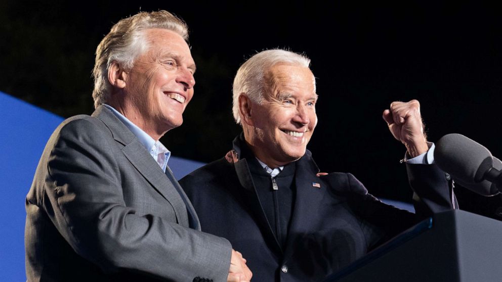 PHOTO: President Joe Biden, right, reacts after speaking at a rally for Democratic gubernatorial candidate, former Virginia Gov. Terry McAuliffe, Tuesday, Oct. 26, 2021, in Arlington, Va.