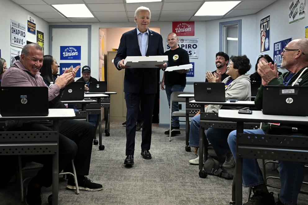 PHOTO: President Joe Biden delivers pizza to thank Democratic campaign volunteers at the Allegheny County Labor Council Headquarters in Pittsburgh, Pa, on Oct. 26, 2024.