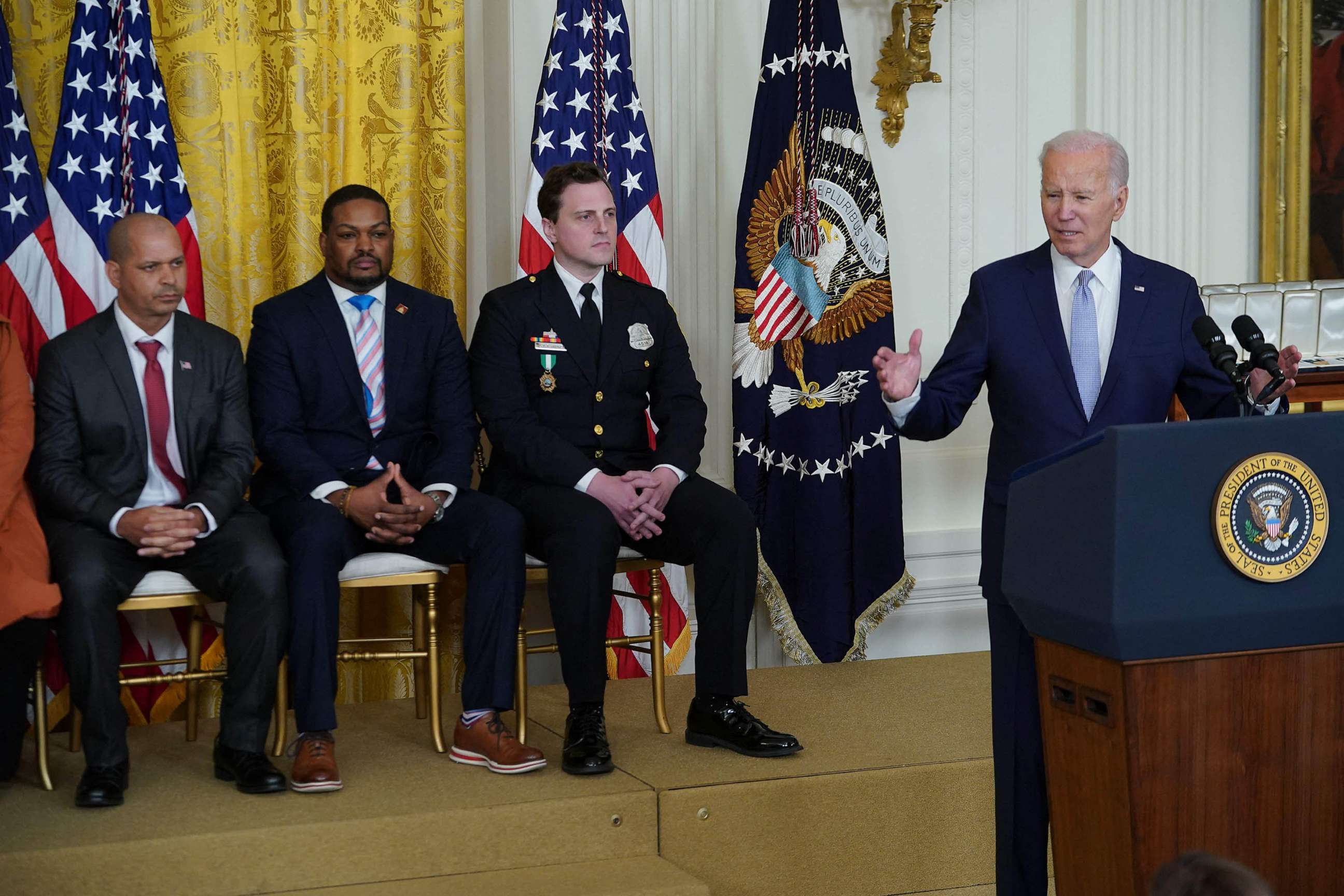 PHOTO: US President Joe Biden (R) speaks on the second anniversary of the January 6, 2021 attack on the US Capitol, during a ceremony in the East Room of the White House in Washington, DC, Jan. 6, 2023.