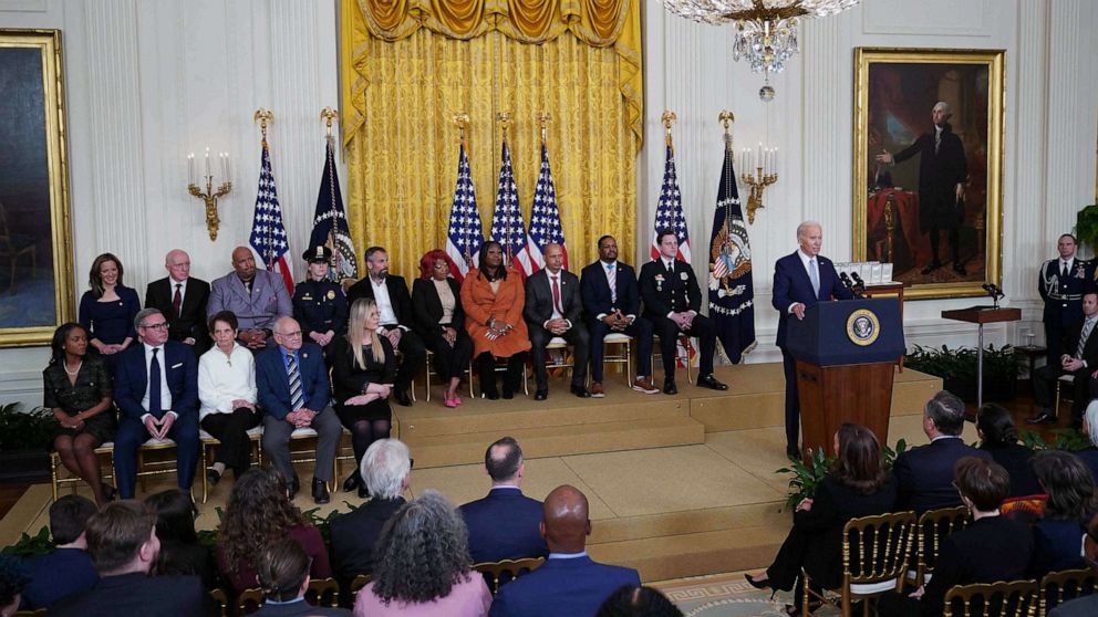 PHOTO: US President Joe Biden (R) speaks on the second anniversary of the January 6, 2021 attack on the US Capitol, during a ceremony in the East Room of the White House in Washington, DC, Jan. 6, 2023.