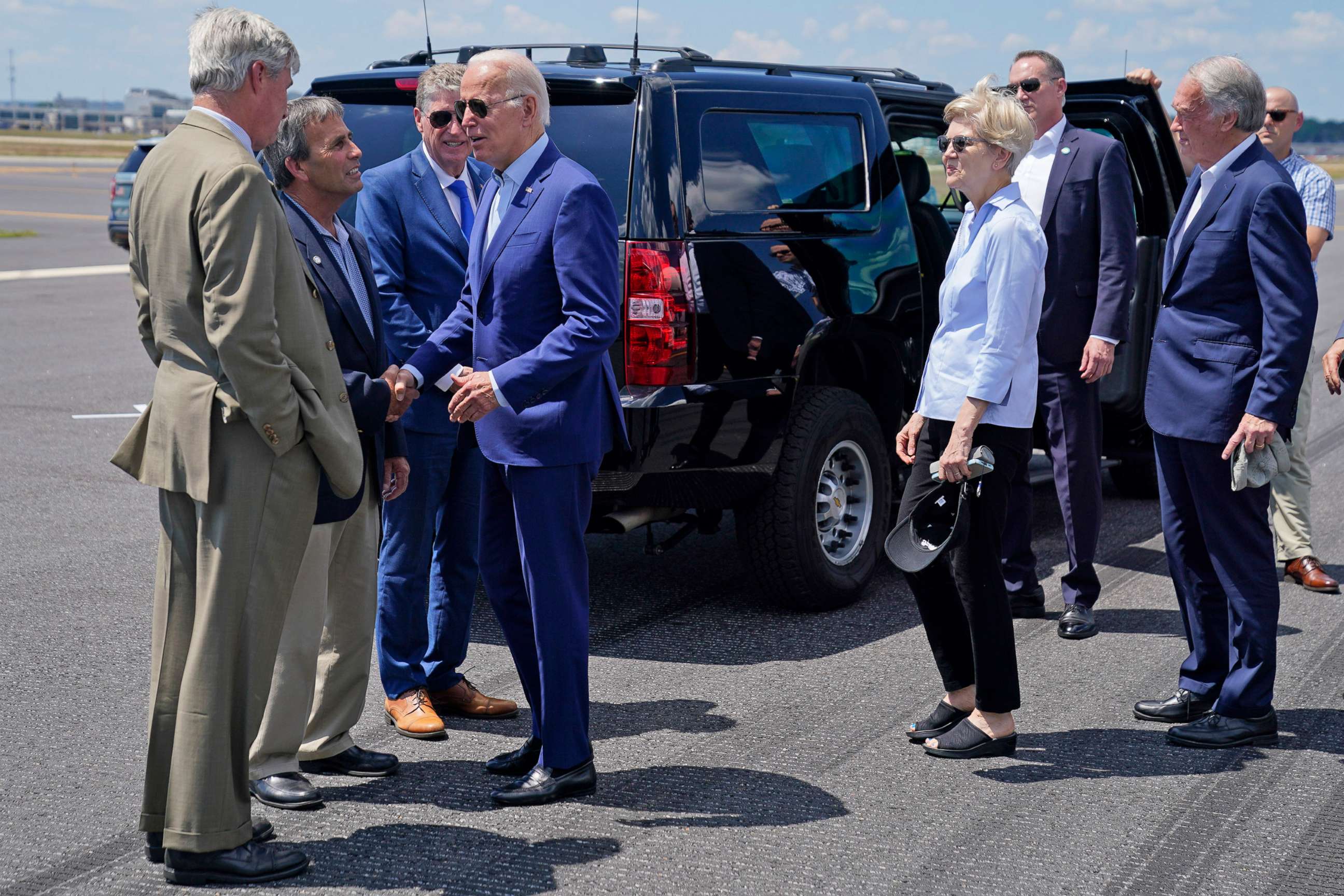 PHOTO: President Joe Biden shakes hands with Mayor of Warwick, R.I., Frank Picozzi, as he arrives in Warwick, R.I.,  July 20, 2022. From left, Sen. Sheldon Whitehouse, Picozzi, R.I. Gov. Dan McKee, Biden, Sen. Elizabeth Warren, and Sen. Ed Markey.