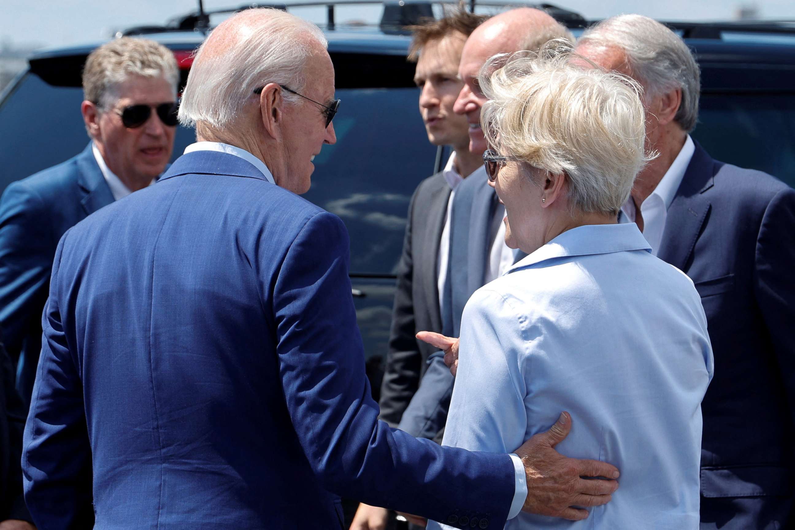 PHOTO: President Joe Biden interacts with Senator Elizabeth Warren and other elected officials after arriving at T.F. Green International Airport in Warwick, R.I., July 20, 2022. 