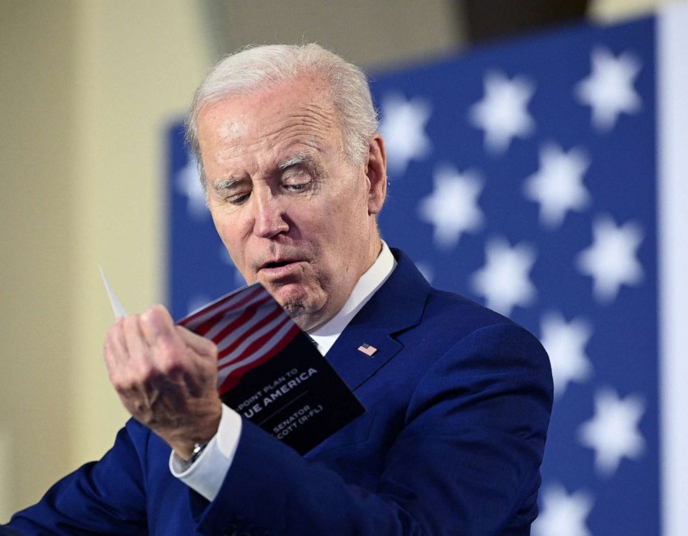 PHOTO: President Joe Biden reads from a pamphlet by Senator Rick Scott, while delivering remarks on his plan to protect and strengthen Social Security and Medicare, as well as lower healthcare costs, in Tampa, Fla., Feb. 9, 2023.