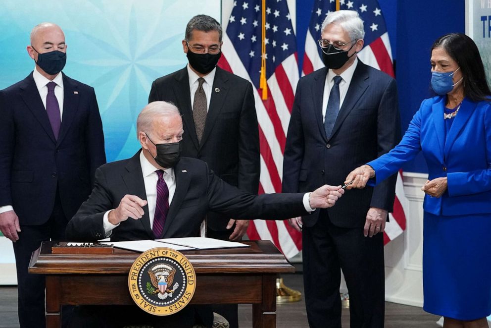 PHOTO: President Joe Biden hands a pen to Secretary of the Interior Deb Haaland after signing a executive order to protect Natives Americans against violence during a Tribal Nations Summit, Nov. 15, 2021, in Washington, D.C.