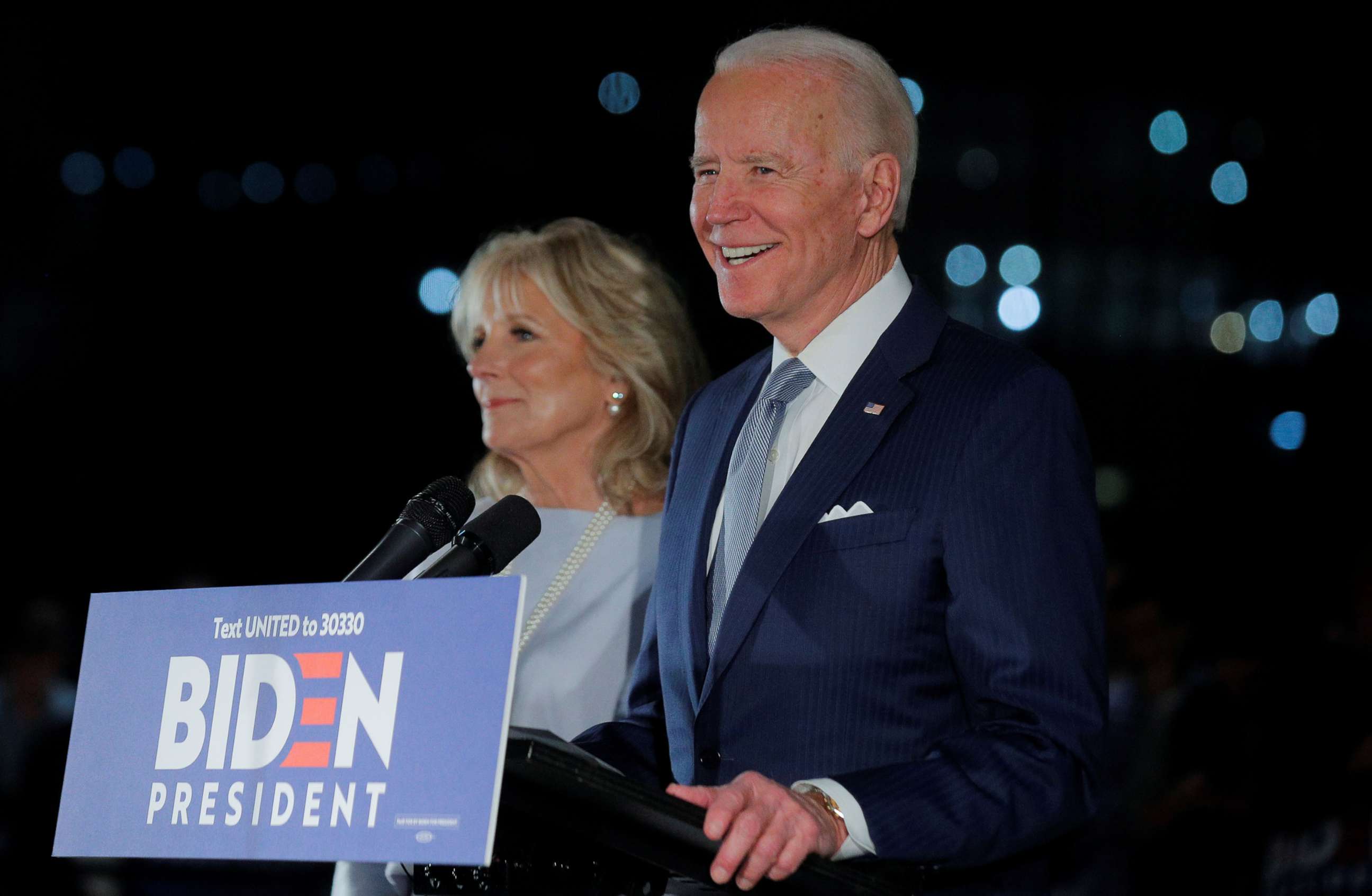 PHOTO: Democratic presidential candidate and former Vice President Joe Biden smiles as he speaks with his wife Jill at his side during a primary night news conference at The National Constitution Center in Philadelphia, March 10, 2020.