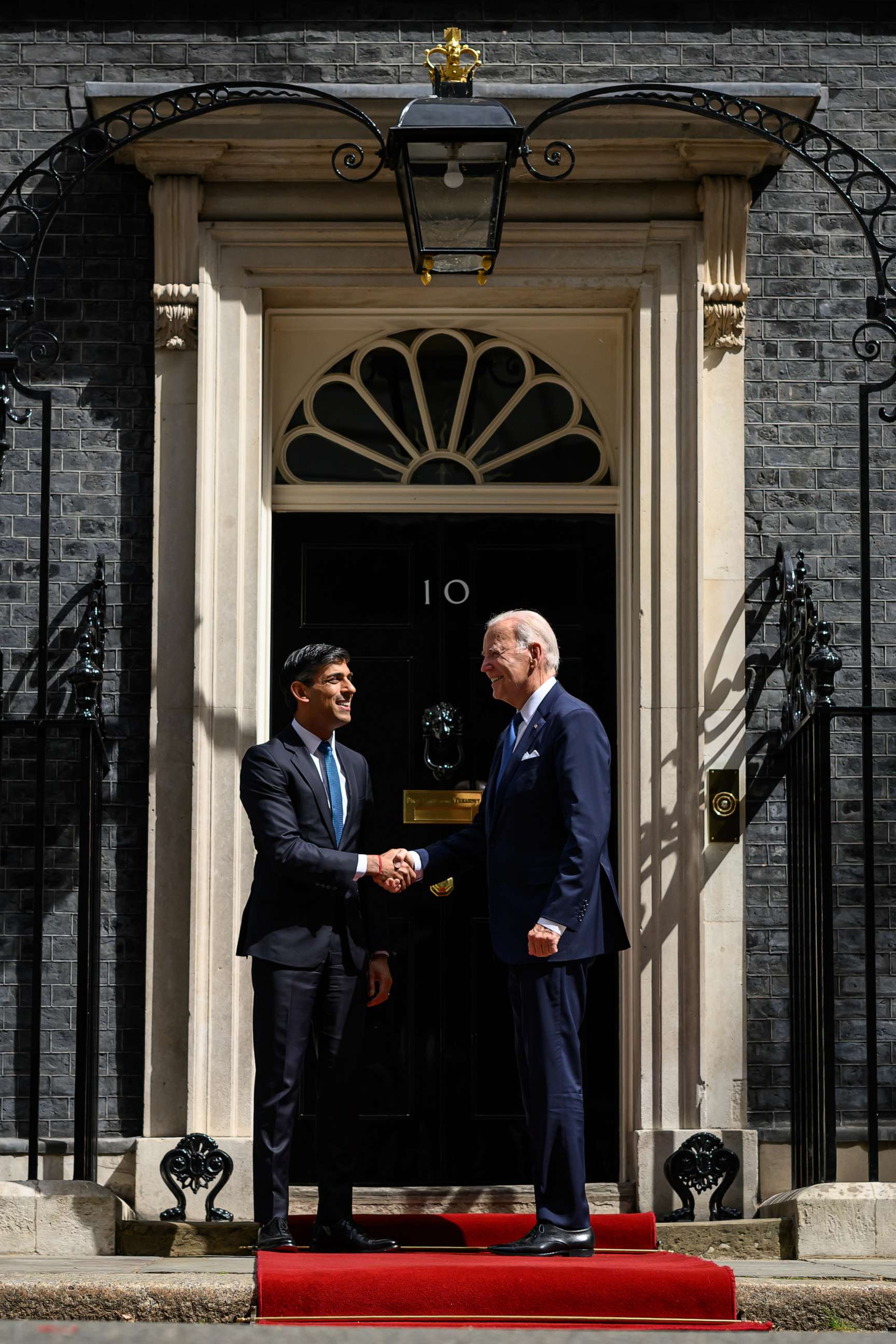 PHOTO: Britain's Prime Minister Rishi Sunak greets US President Joe Biden on the doorstep of 10 Downing Street ahead of a bi-lateral meeting on July 10, 2023 in London.