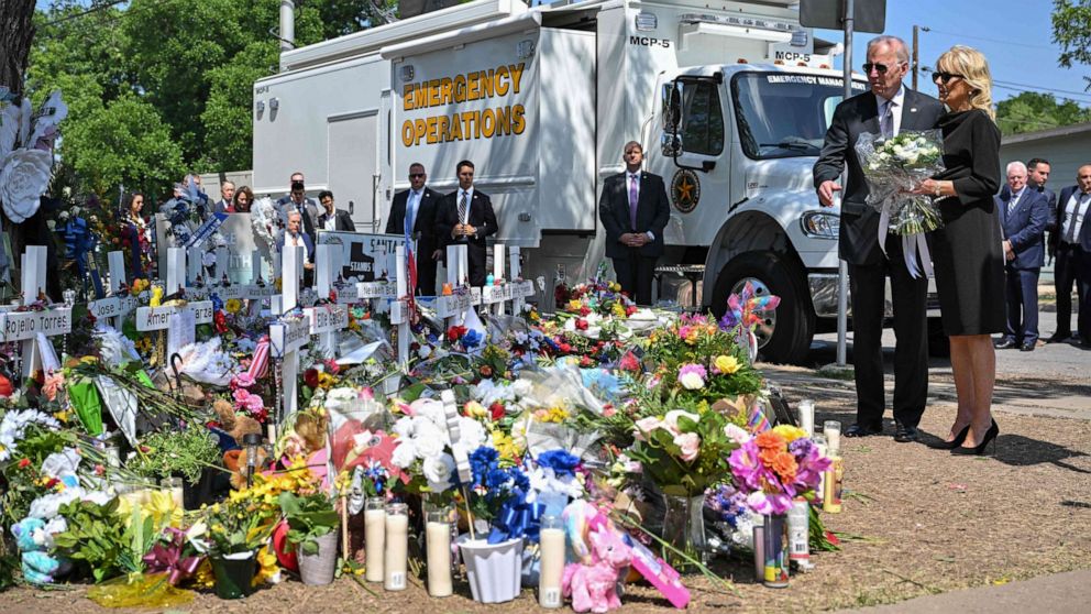 PHOTO: President Joe Biden and First Lady Jill Biden pay their respects at a makeshift memorial outside of Robb Elementary School in Uvalde, Texas on May 29, 2022.