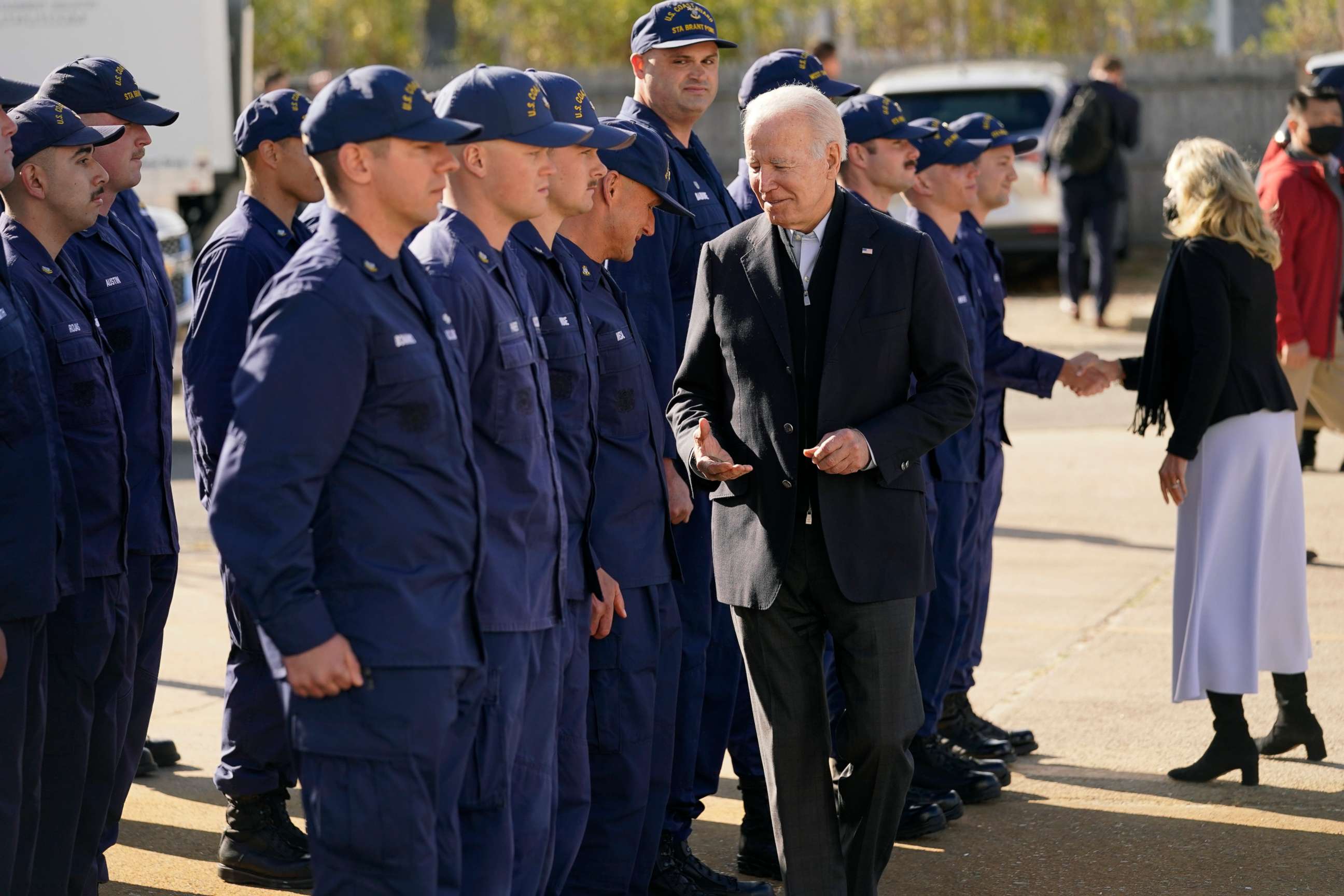 PHOTO: President Joe Biden hands out challenge coins as he and first lady Jill Biden meet with members of the Coast Guard at the United States Coast Guard Station Brant Point in Nantucket, Mass., Nov. 25, 2021.