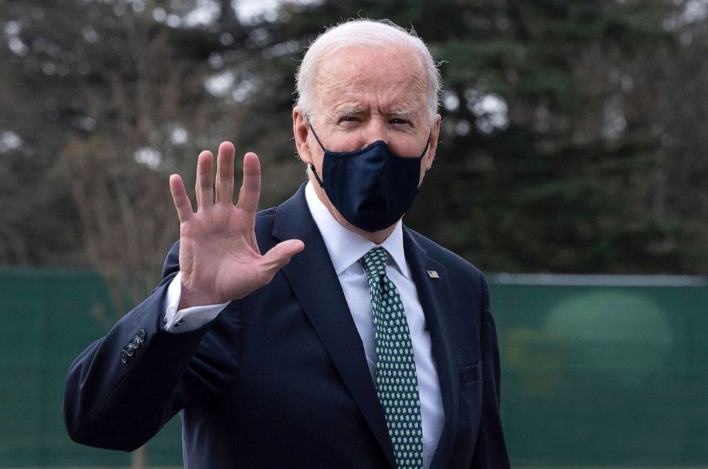PHOTO: President Joe Biden, wearing a tie for St. Patrick's Day, waves as he walks off Marine One upon his arrival at the White House, March 17, 2021.