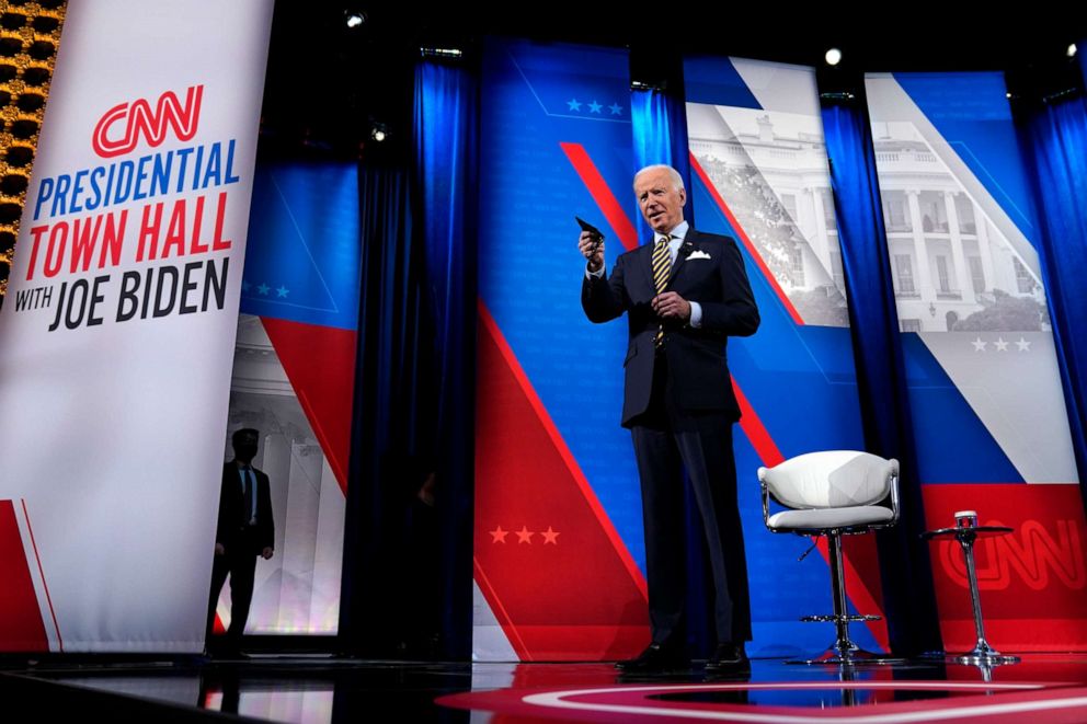 PHOTO: President Joe Biden stands on stage during a break in a televised town hall event at Pabst Theater on Tuesday, Feb. 16, 2021, in Milwaukee. 