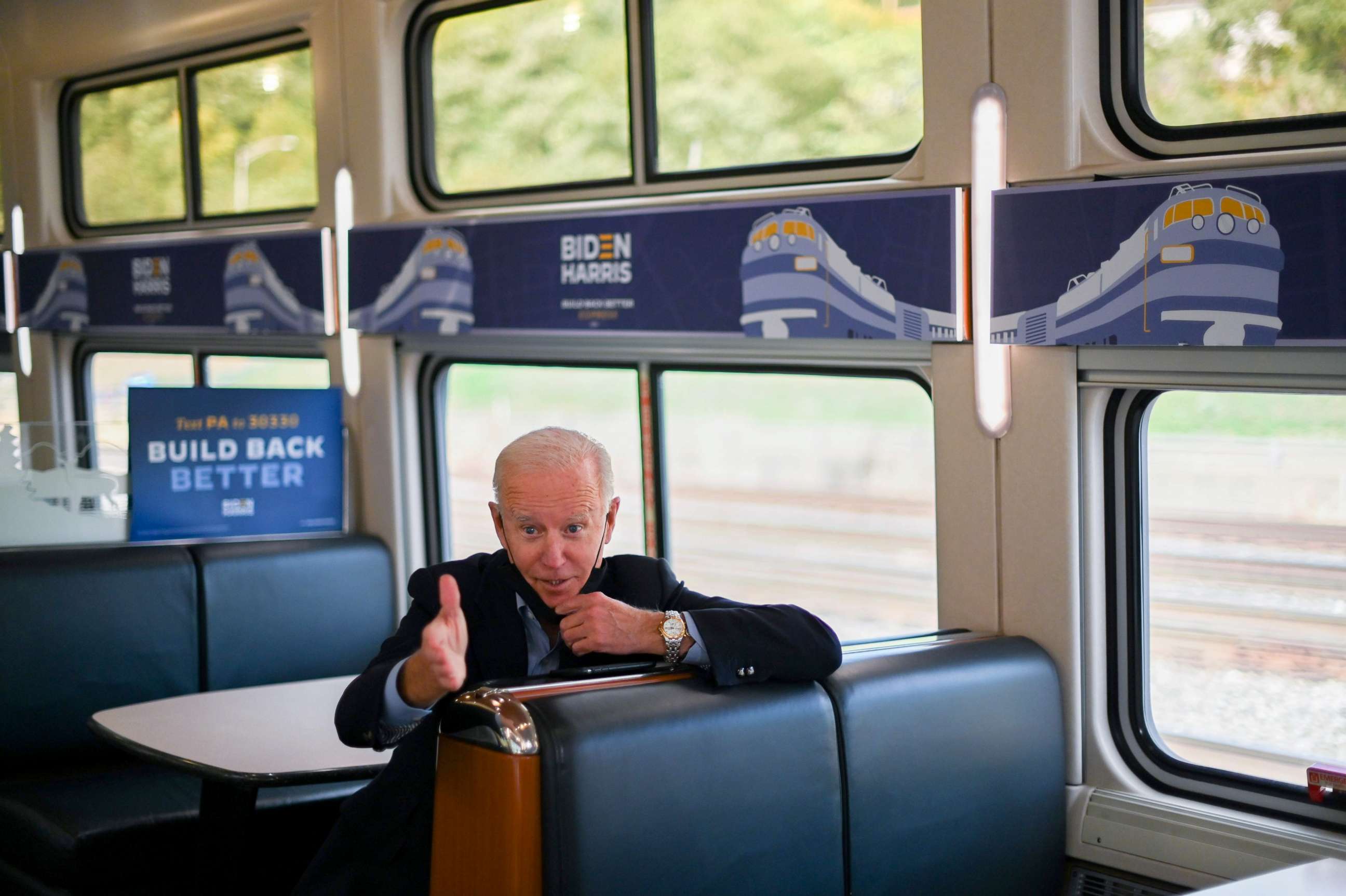 PHOTO: Democratic presidential nominee and former Vice President Joe Biden speaks to teacher Denny Flora (not shown) as they ride a train to Pittsburgh, Pennsylvania, Sept. 30, 2020.