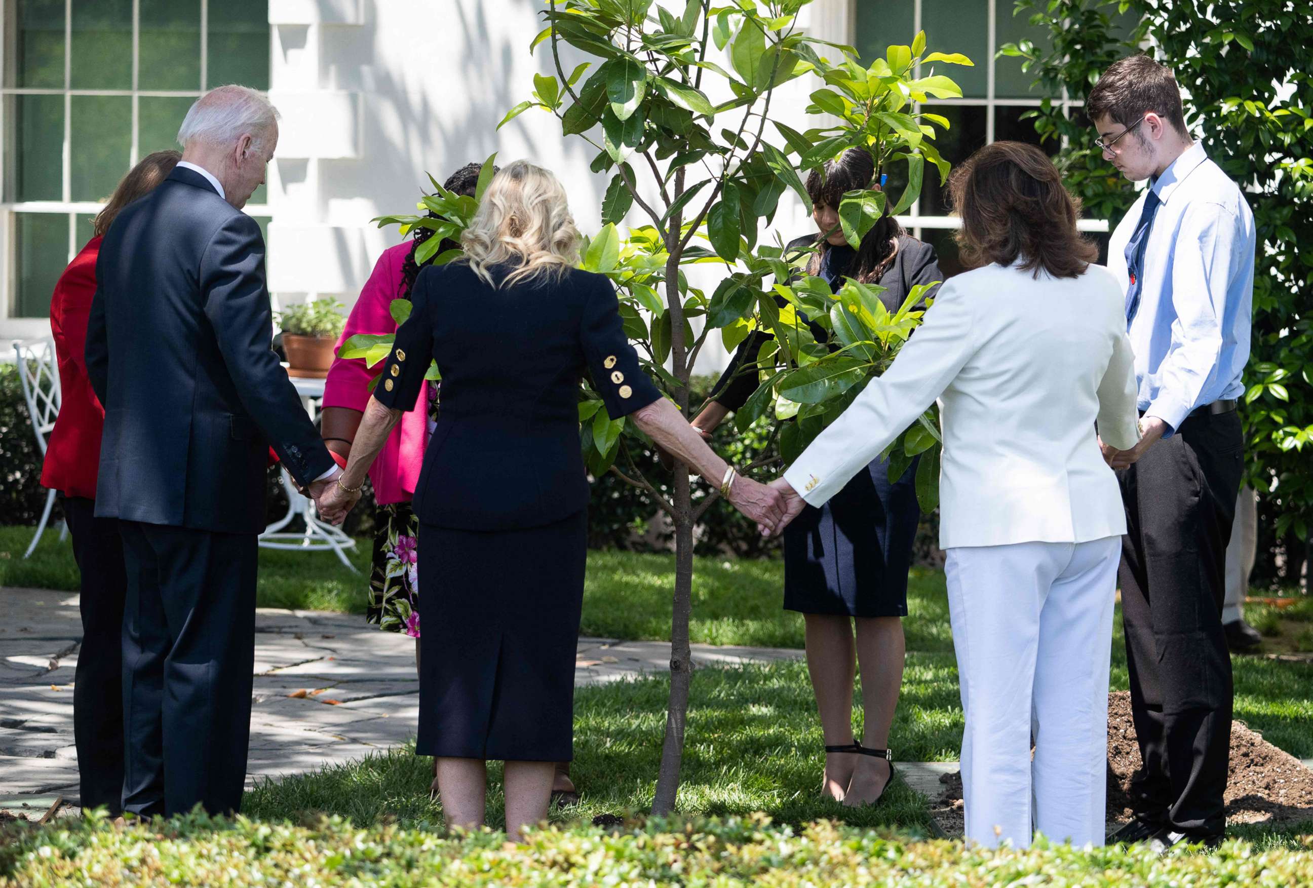 PHOTO: President Joe Biden and First Lady Jill Biden pray as they participate in a tree planting ceremony, in honor of Memorial Day, on the South Lawn of the White House in Washington, D.C., on May 30, 2022.