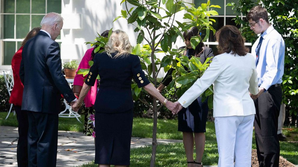 PHOTO: President Joe Biden and First Lady Jill Biden pray as they participate in a tree planting ceremony, in honor of Memorial Day, on the South Lawn of the White House in Washington, D.C., on May 30, 2022.