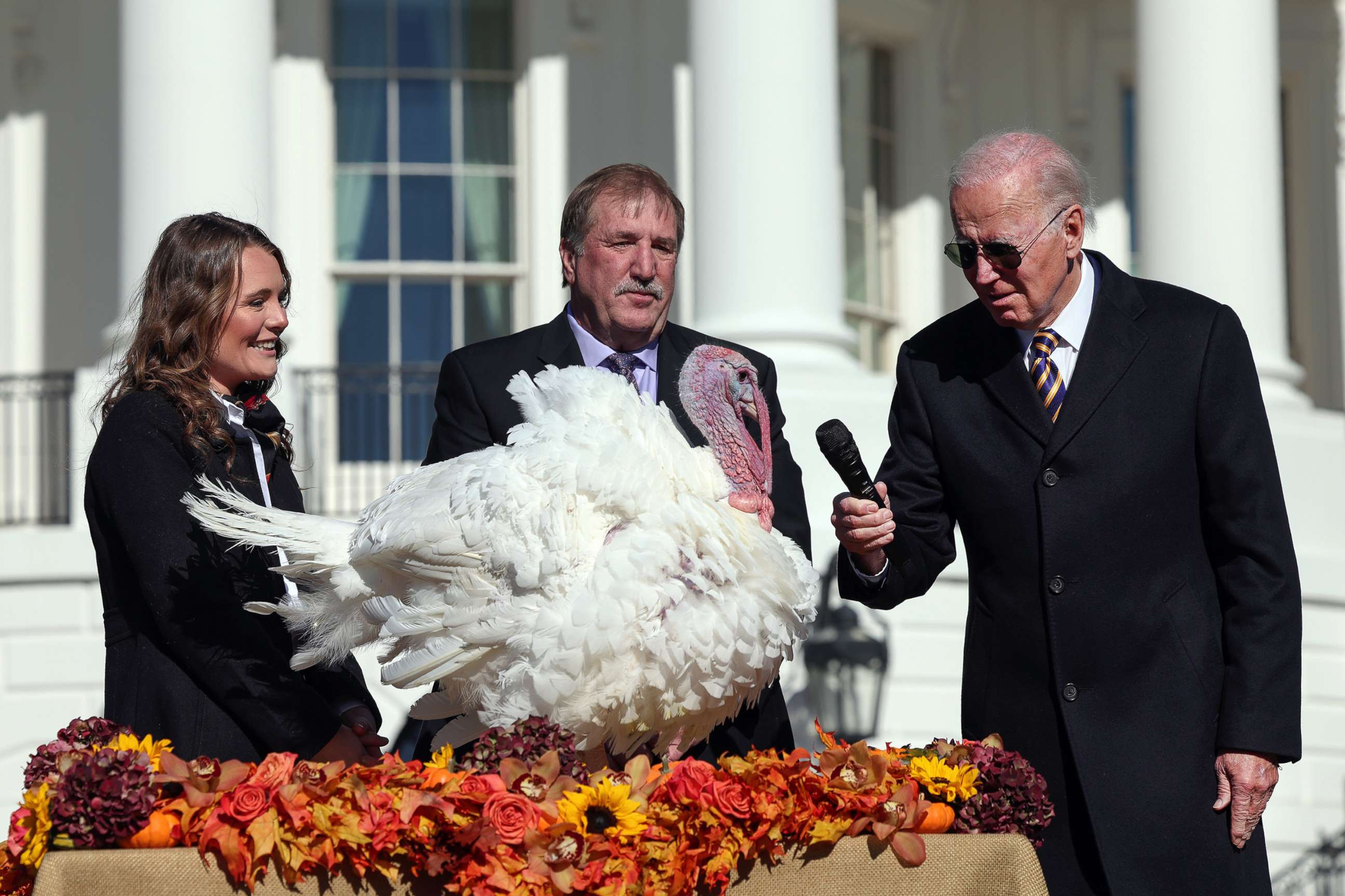 PHOTO: President Joe Biden gives the mic to Chocolate, the National Thanksgiving Turkey, after pardoning him and Chip, on the South Lawn of the White House, Nov. 21, 2002. 