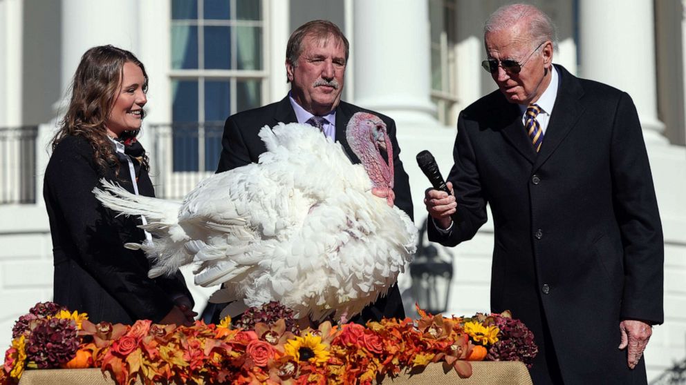 PHOTO: President Joe Biden gives the mic to Chocolate, the National Thanksgiving Turkey, after pardoning him and Chip, on the South Lawn of the White House, Nov. 21, 2002. 