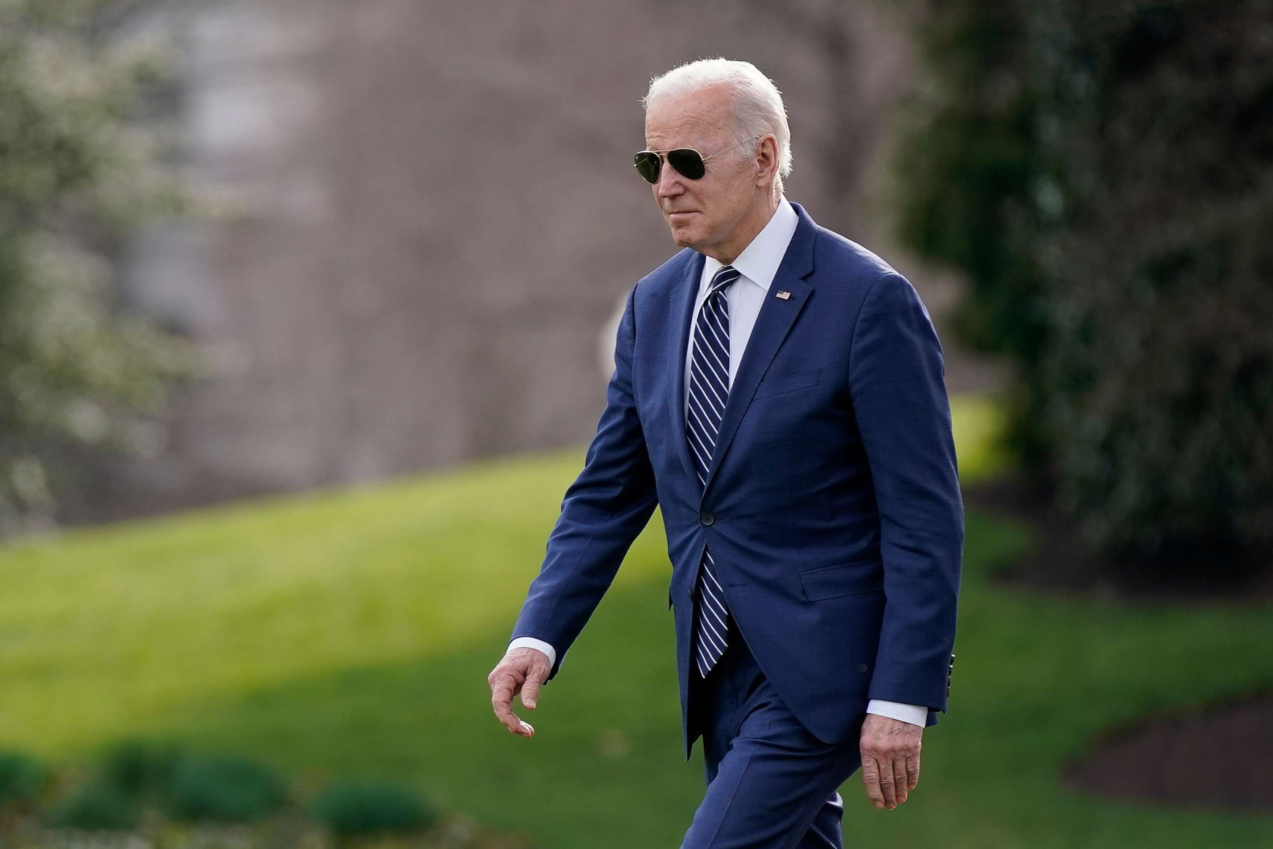PHOTO: President Joe Biden walks on the South Lawn of the White House before boarding Marine One, March 18, 2022.