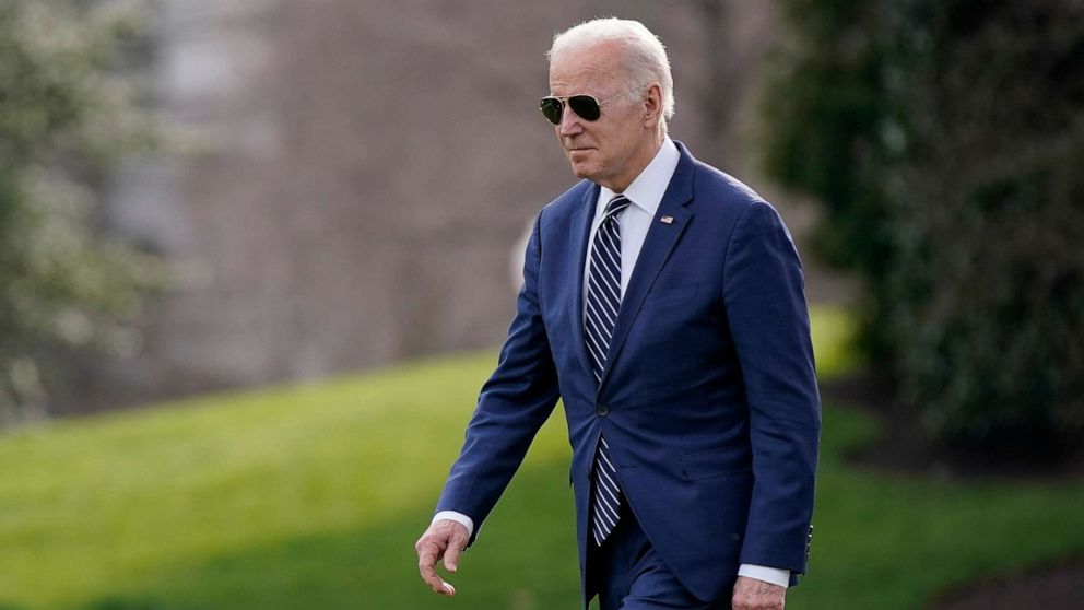 PHOTO: President Joe Biden walks on the South Lawn of the White House before boarding Marine One, March 18, 2022.
