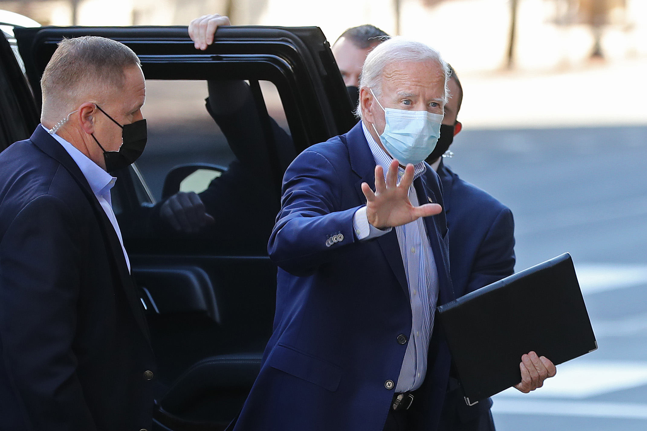 PHOTO: Wearing a face mask to reduce the risk posed by the coronavirus, Democratic presidential nominee Joe Biden waves to journalists as he enters The Queen performance venue Oct. 3, 2020, in Wilmington, Del.