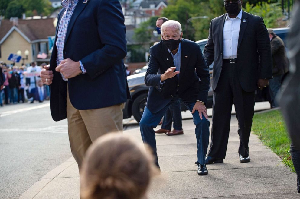 PHOTO: Democratic presidential nominee and former Vice President Joe Biden gets low to wave at supporters outside the Greensburg Train Station in Greensburg, Pa., Sept. 30, 2020, during a train campaign tour.