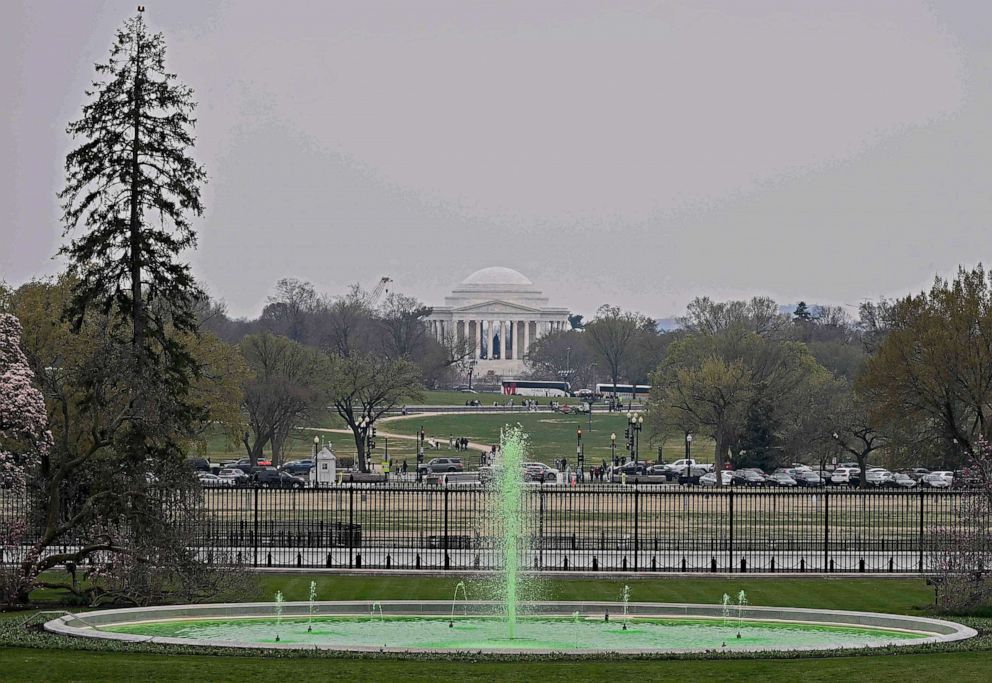 PHOTO: A green fountain is seen on the south lawn in honor of St. Patricks Day at the White House, March 17, 2023.