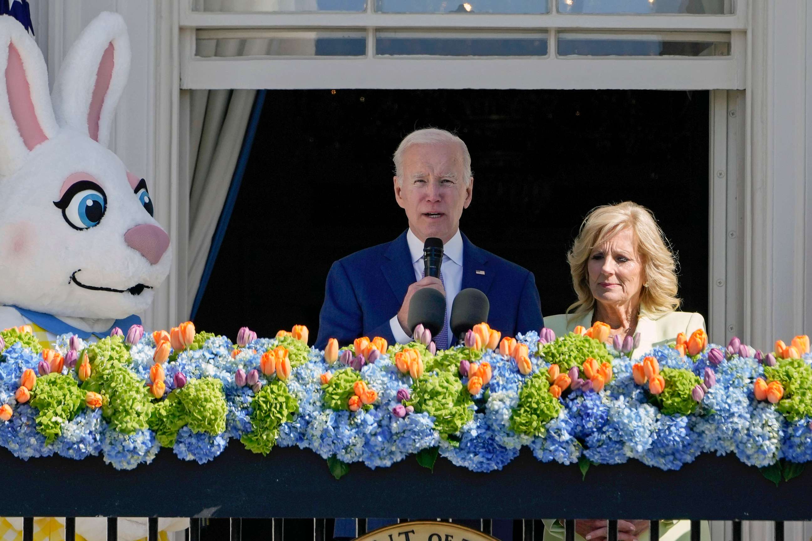 PHOTO: President Joe Biden, accompanied by first lady Jill Biden, speaks on the Blue Room Balcony during the 2023 White House Easter Egg Roll, April 10, 2023, in Washington.