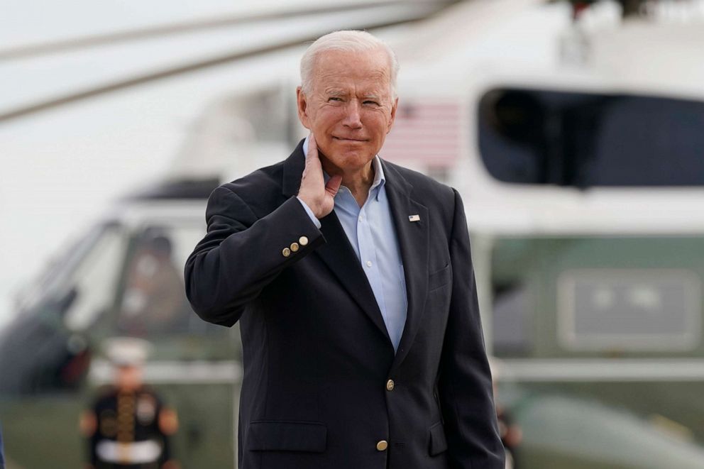 PHOTO: President Joe Biden pantomimes how he earlier had to brush a cicada off his neck as he and first lady Jill Biden prepare to board Air Force One, June 9, 2021, at Andrews Air Force Base, Md.