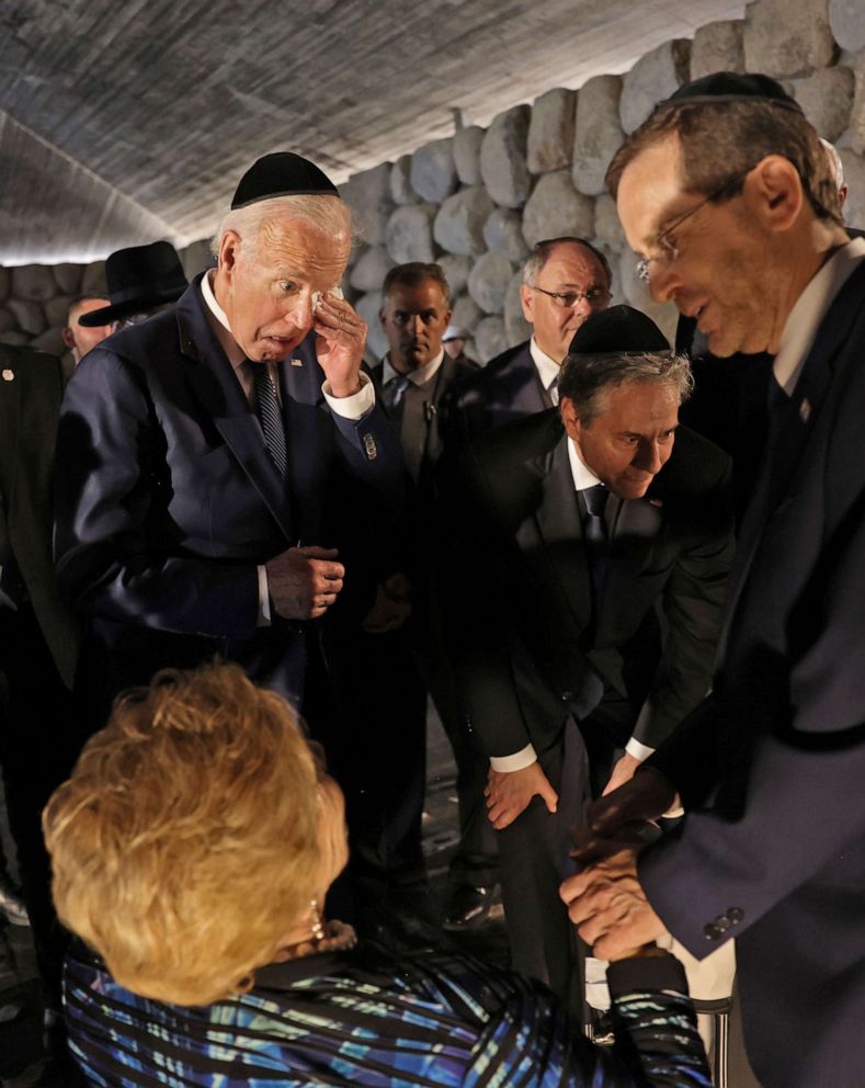 President Biden wipes his eye as he stands with Secretary of State Blinken, while Israel's President Herzog speaks with Holocaust survivor Rena Quint at the Hall of Remembrance of the Yad Vashem Holocaust Memorial Museum, in Jerusalem, July 13, 2022.