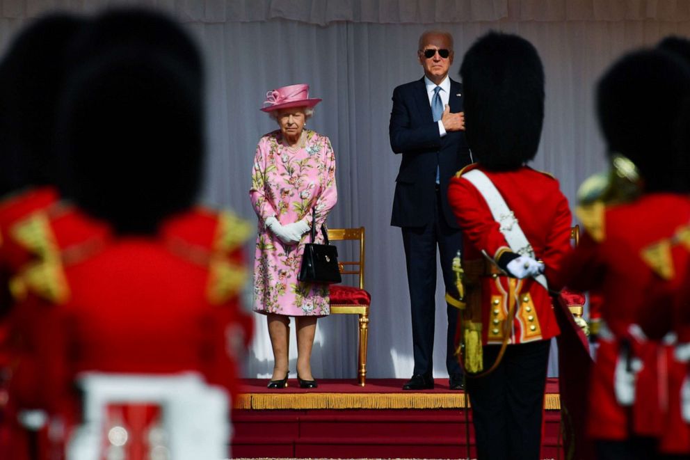 PHOTO: Queen Elizabeth stands and President Joe Biden in front of members of the Royal Guard at Windsor Castle near London, June 13, 2021.