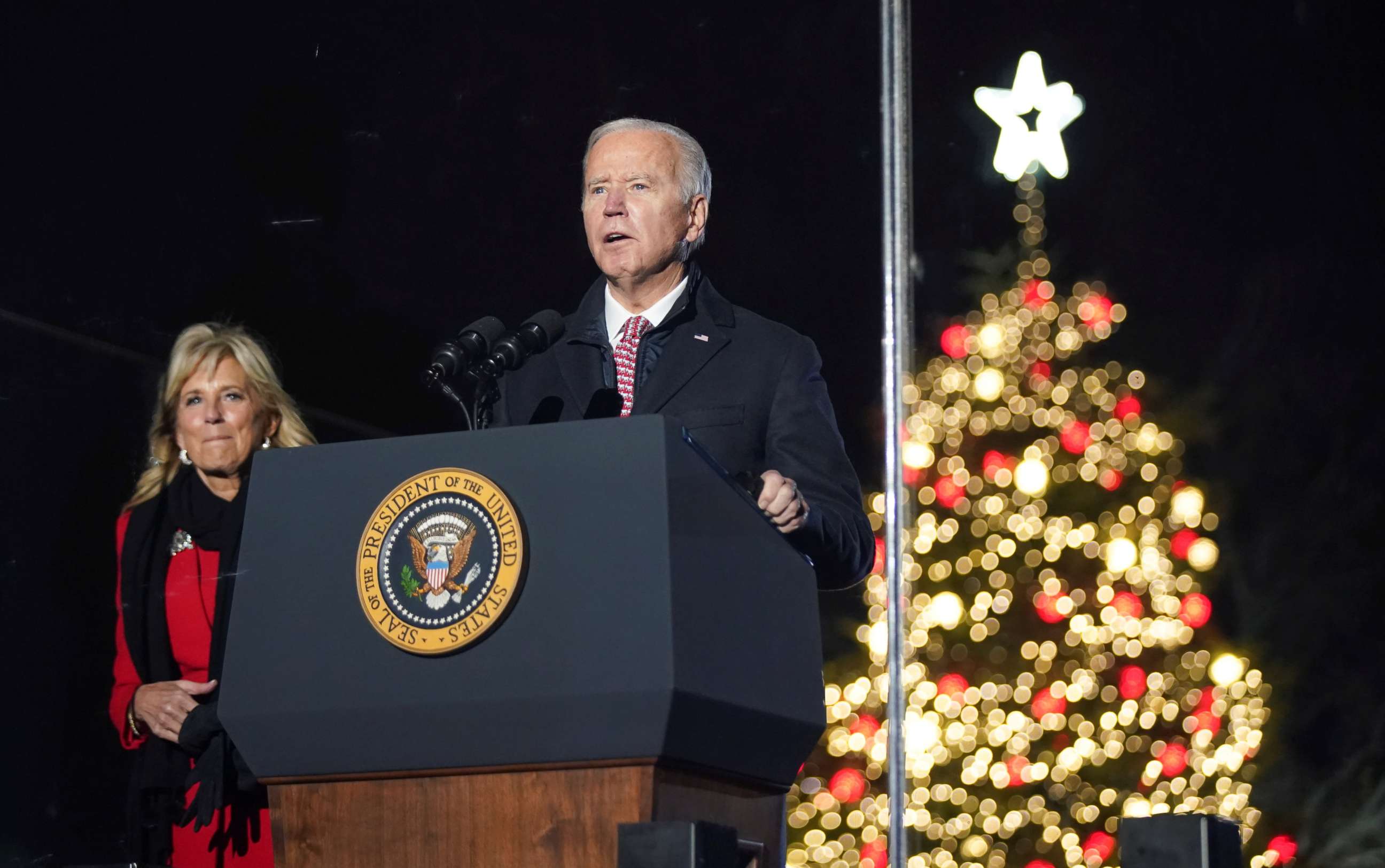 PHOTO: President Joe Biden, with first lady Jill Biden at his side, speaks during the National Christmas Tree Lighting ceremony in Washington, Dec. 2, 2021.