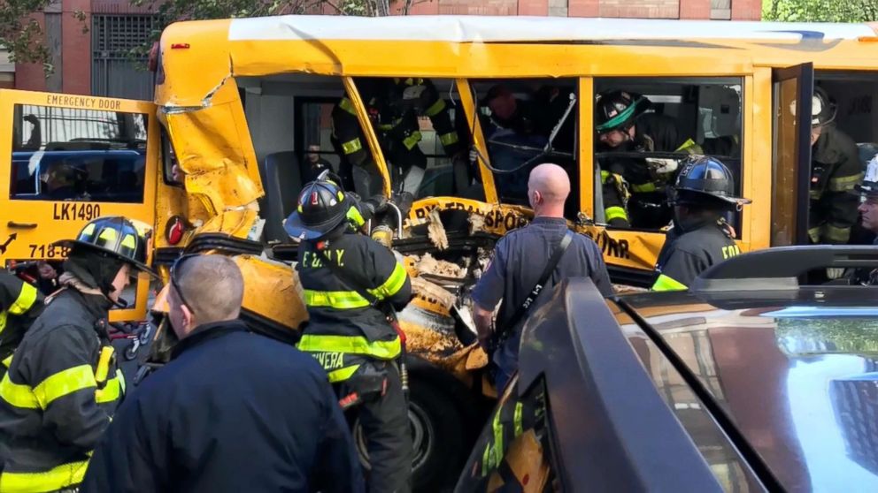 PHOTO: Emergency personnel work on a school bus after a driver rammed into it in New York City, Oct. 31, 2017. Investigators are working to determine what led a pickup truck driver to plow down people on a riverfront bike path near the World Trade Center.