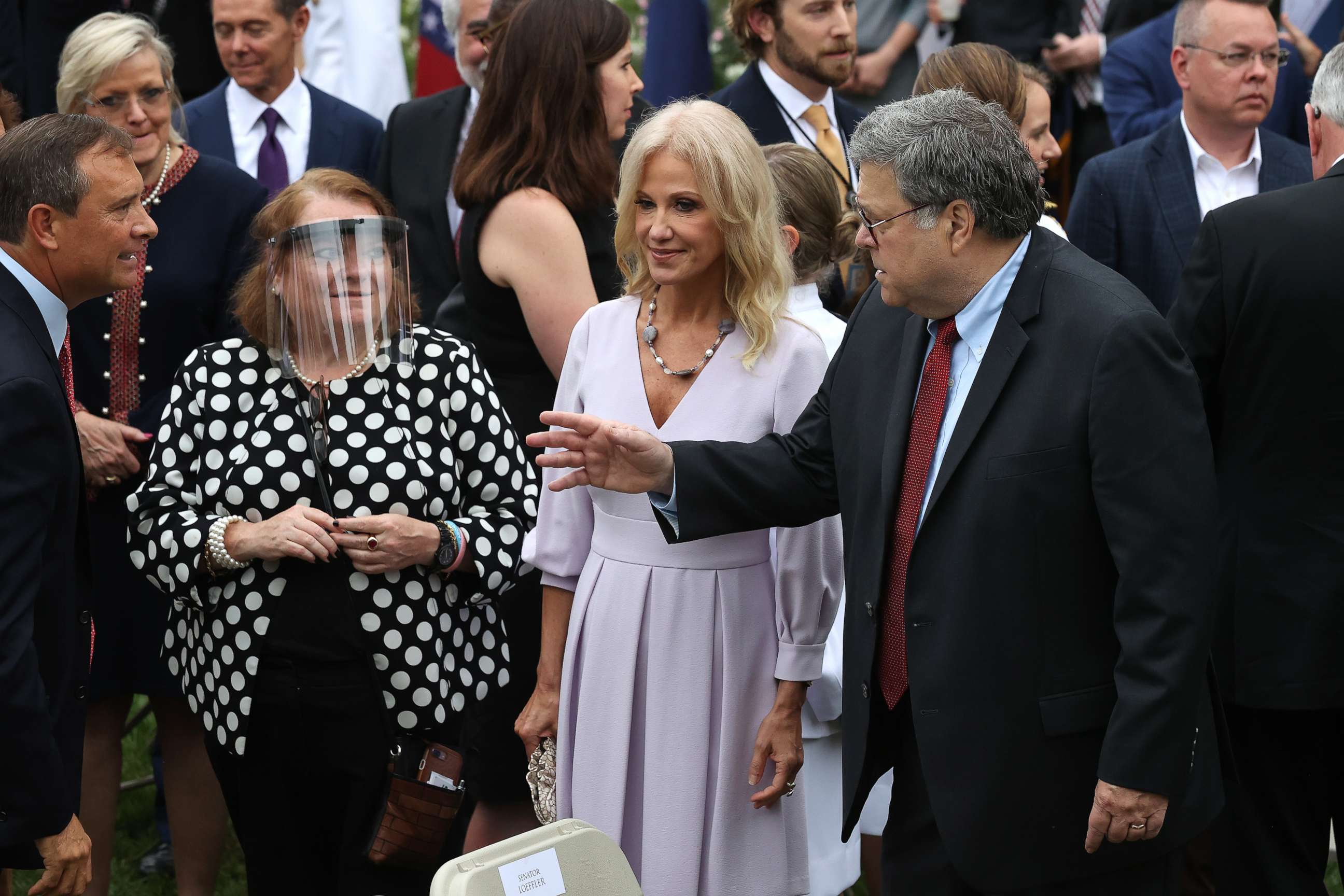PHOTO: Former counselor to the president Kellyanne Conway, center, and Attorney General William Barr talk with guests in the Rose Garden after President Donald Trump introduced Amy Coney Barrett as nominee to the Supreme Court, Sept. 26, 2020.