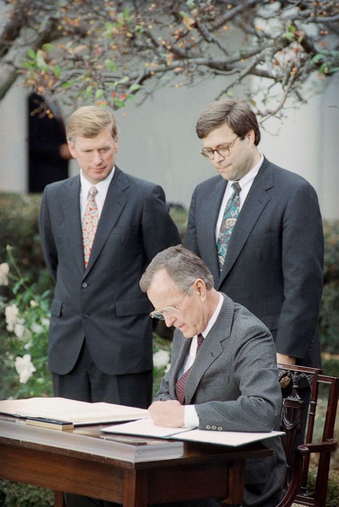 File photo: President George H. Bush signs into law new civil rights guarantees for women and minorities at a Rose Garden ceremony on Nov. 21, 1991, in Washington, as Vice President Dan Quayle, left, and Acting Attorney General William Barr look on.