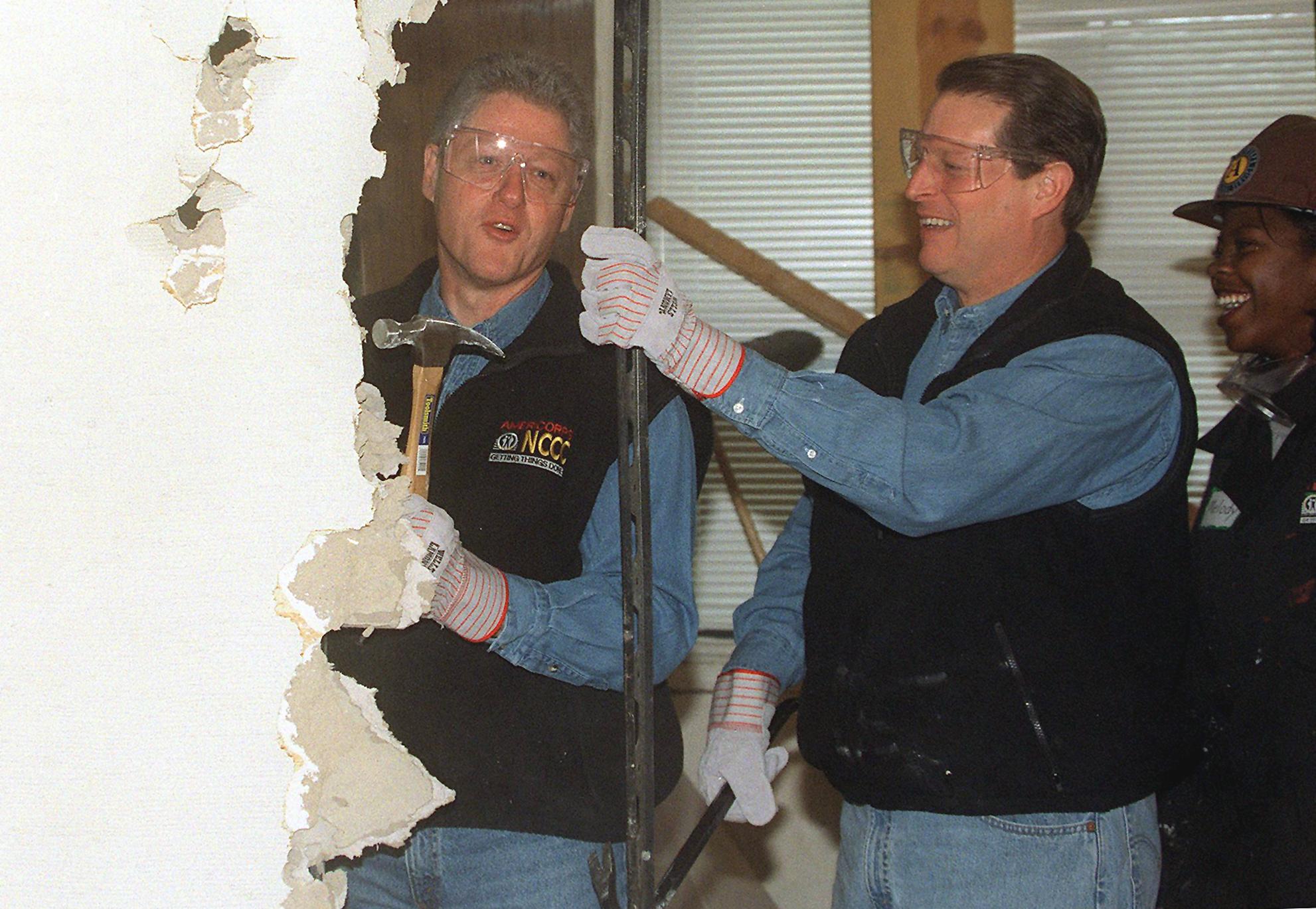 PHOTO: President Bill Clinton, Vice President Al Gore tear down a wall to begin renovation of the Regency House, a senior health center, Jan. 18, 1999 in Washington. 