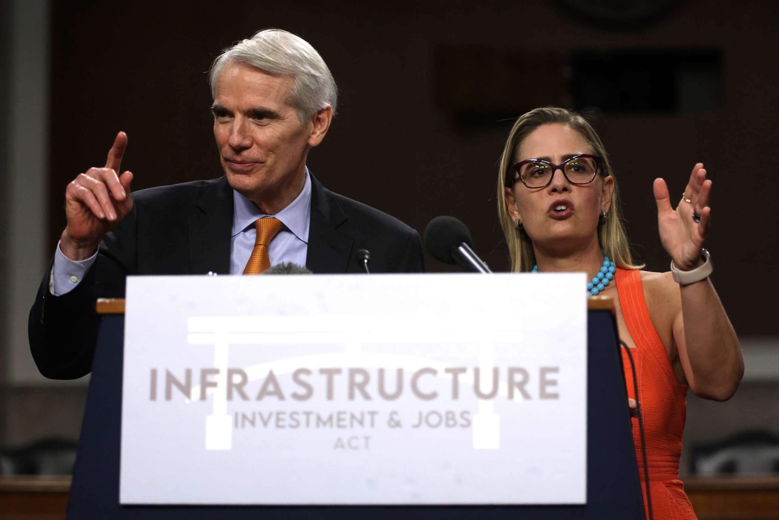 PHOTO: *** BESTPIX *** WASHINGTON, DC - JULY 28:  U.S. Sen. Rob Portman (R-OH) (L) and Sen. Kyrsten Sinema (D-AZ) (R) answer questions from members of the press during a news conference after a procedural vote for the bipartisan infrastructure framework.